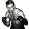 Fighter: Petey Sarron was a member of the U. S. Olympic Team as a flyweight during the 1924 Olympics. He also had a very successful pro career winning the world title and successfully defending his belt twice before losing it to the great Henry Armstrong in 1937. His final ring record was 100-23-12.